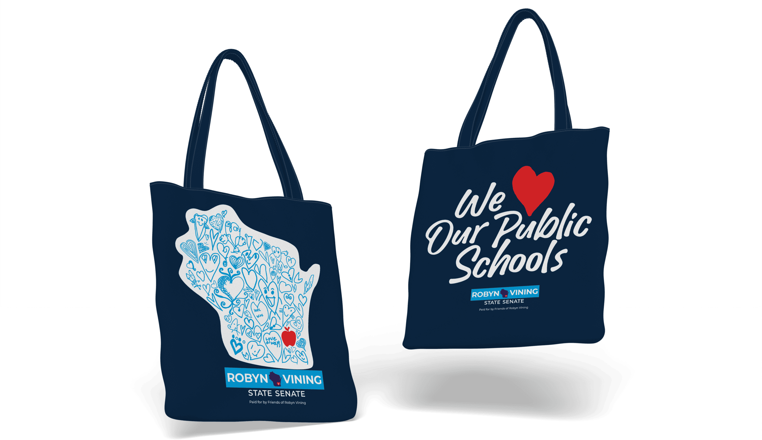 Two dark blue tote bags: one features a Wisconsin-shaped graphic filled with heart doodles and the Robyn Vining State Senate logo, while the other reads We [heart icon] Our Public Schools with the Robyn Vining State Senate logo below.